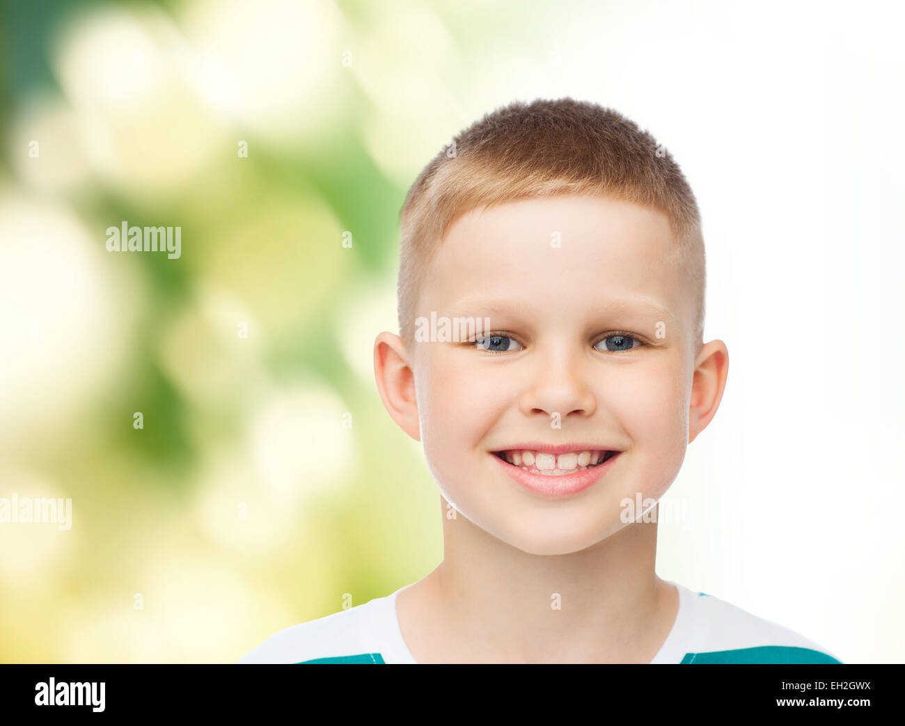 smiling little boy over green background Stock Photo