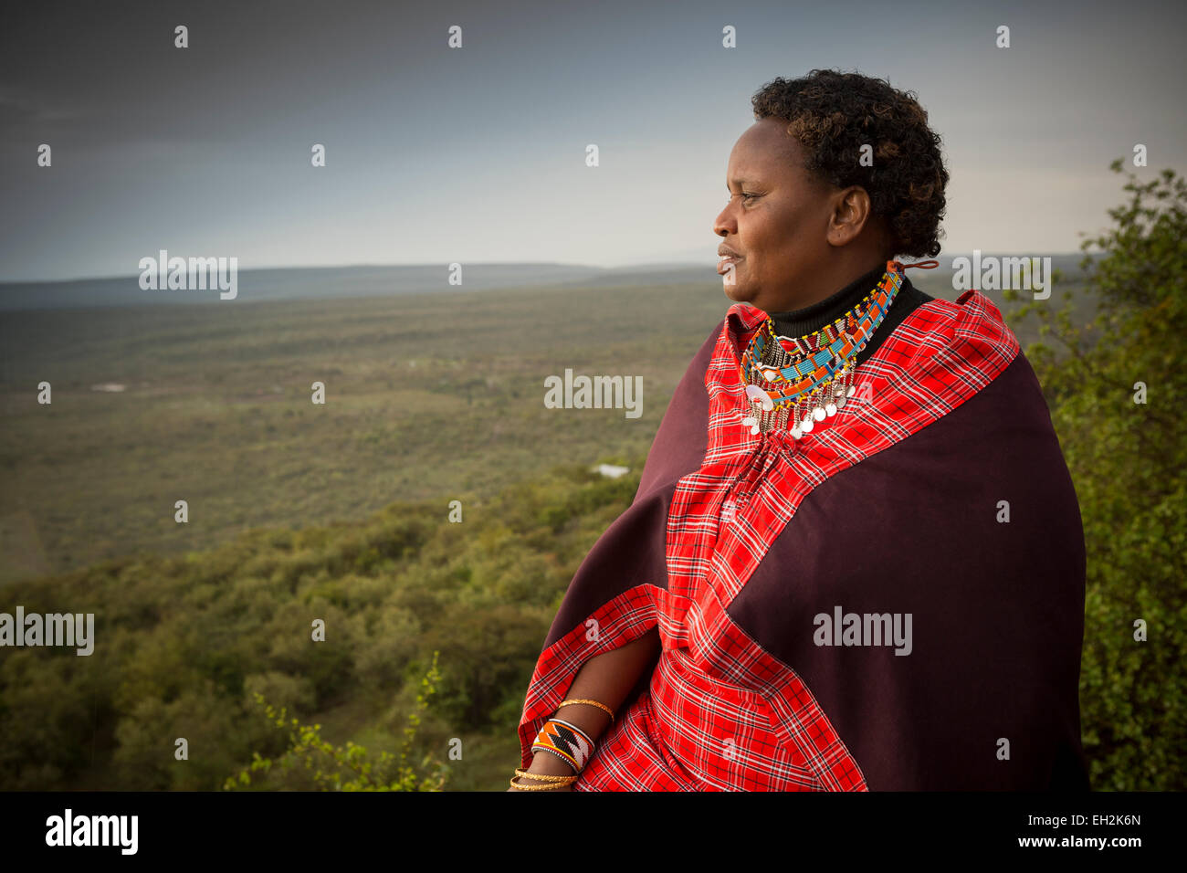 A Massai woman looks out over the rift valley - Ngong Hills, Kenya. Stock Photo