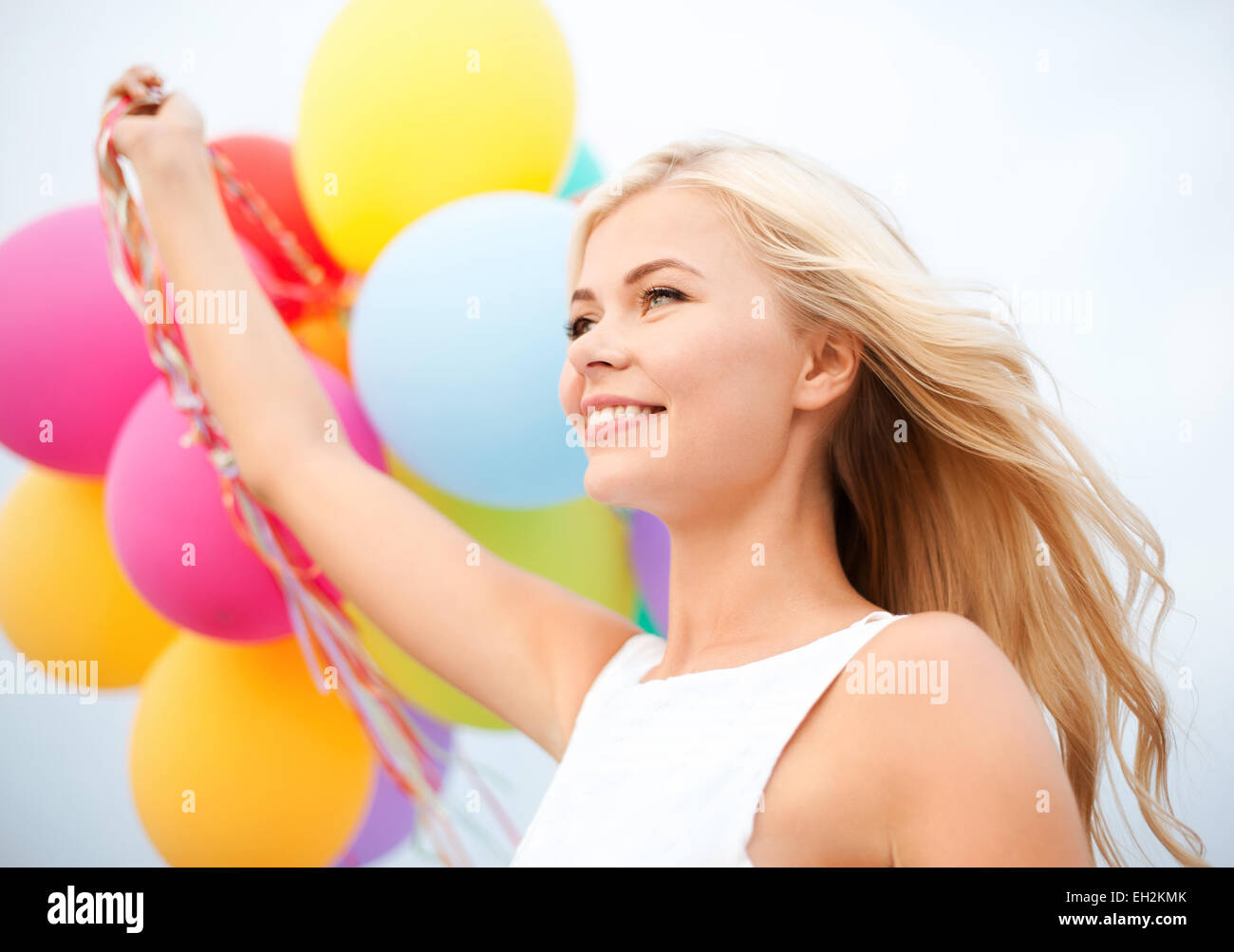 woman with colorful balloons outside Stock Photo