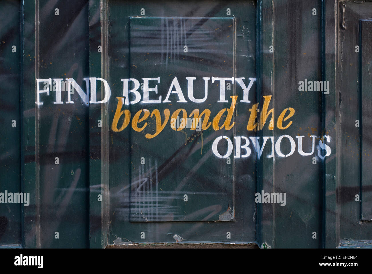 A painted panel on a Public House in Edinburgh with the words, 'Find beauty beyond the obvious'. Stock Photo