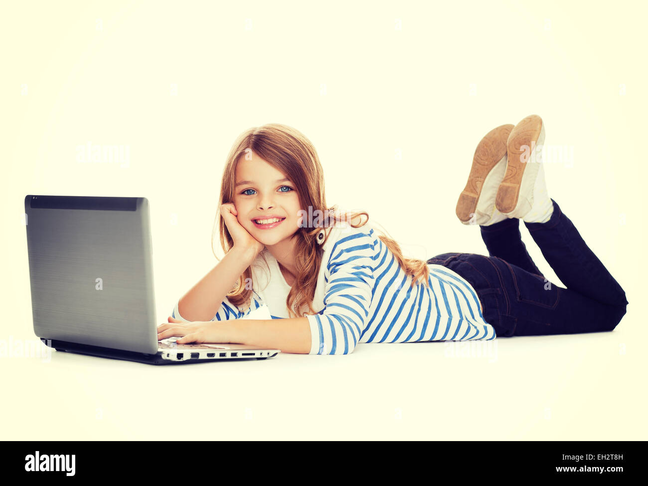 smiling student girl with laptop computer lying Stock Photo - Alamy