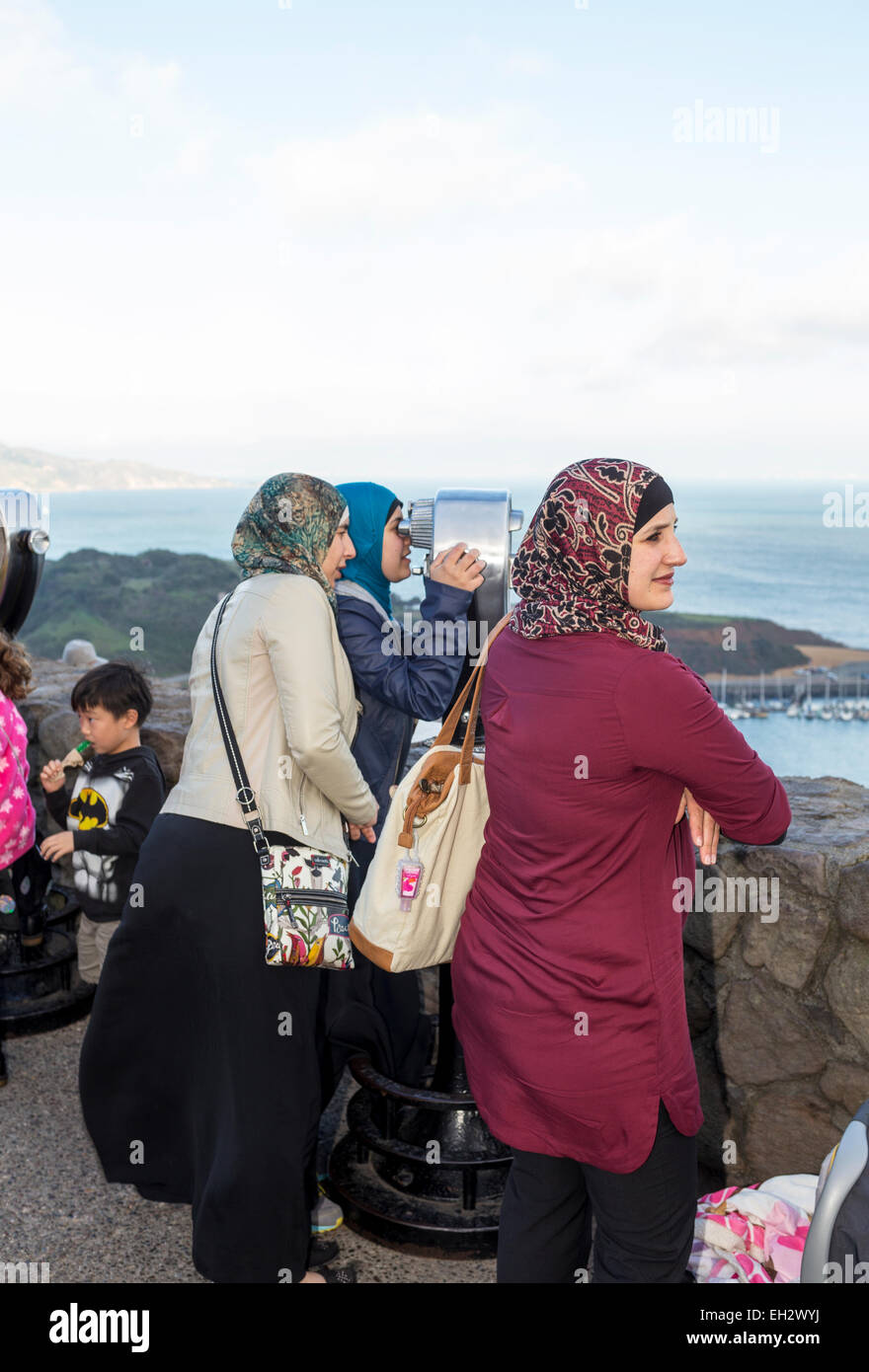 adult women, tourists, visitors, looking through viewfinder, north side of Golden Gate Bridge, Vista Point, city of Sausalito, California Stock Photo