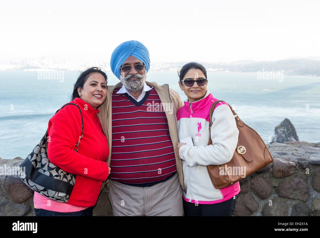 3, tourists, family, father, mother, daughter, posing for photograph, Vista Point, north side of Golden Gate Bridge, city of Sausalito, California Stock Photo