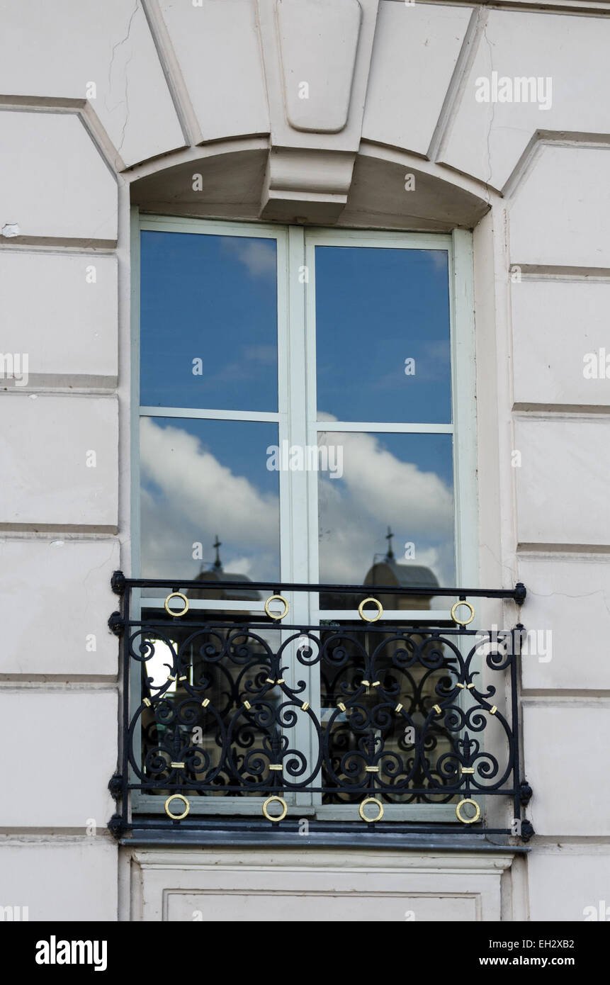 A tall window on the Île Saint Louis reflects sky and buildings, Paris, France. Stock Photo