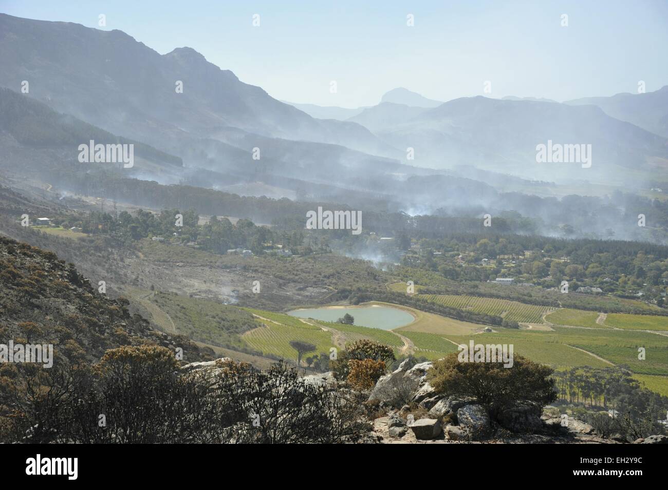 Cape Town, South Africa. 5th March, 2015. Fires still smouldering around Constantia and Tokai viewed from Silvermine on Ou Kaapse Weg after five days of wild fires that have destroyed thousands of hectares of land on the Cape Peninsula south of Table Mountain.  The fires stretched across the mountain from Muizenburg in the east over to Hout Bay and Fishhoek in the west. Strong winds have been hampering efforts to contain the fires. Credit:  STUART WALKER/Alamy Live News Stock Photo
