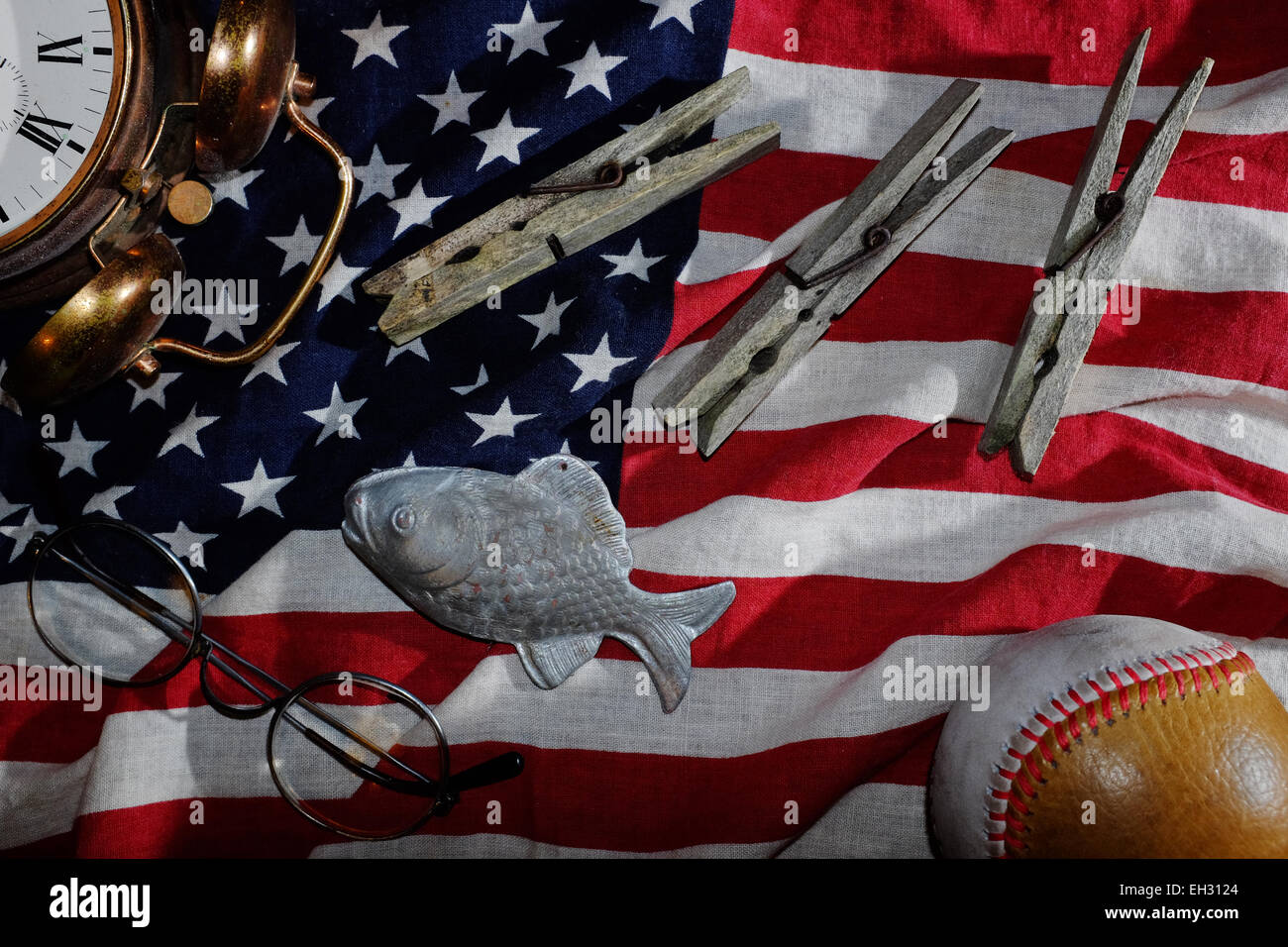 vintage still life, the American flag, an old alarm clock, glasses, baseball, clothespins, fish Stock Photo