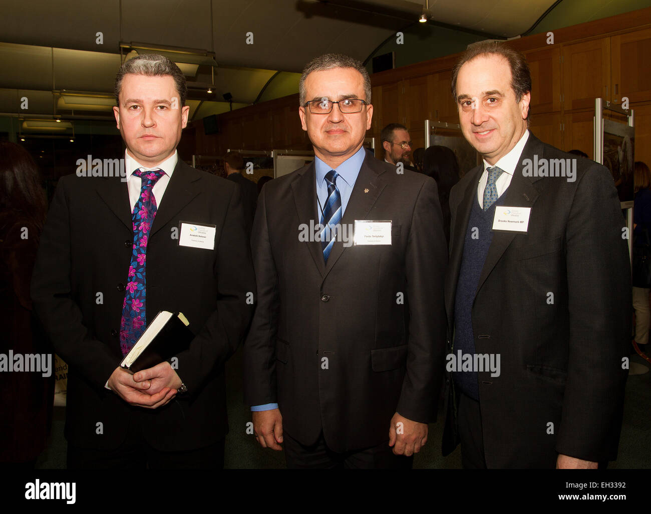 Anatolii Solovei (L) Pavlo Tertytskyi (C) Brooks Newmark MP (R) at the Global Friends of Ukraine photographic exhibition at the House of Commons to launch Victims of War Support Project. London, United Kingdom. 05.03.2015 Stock Photo