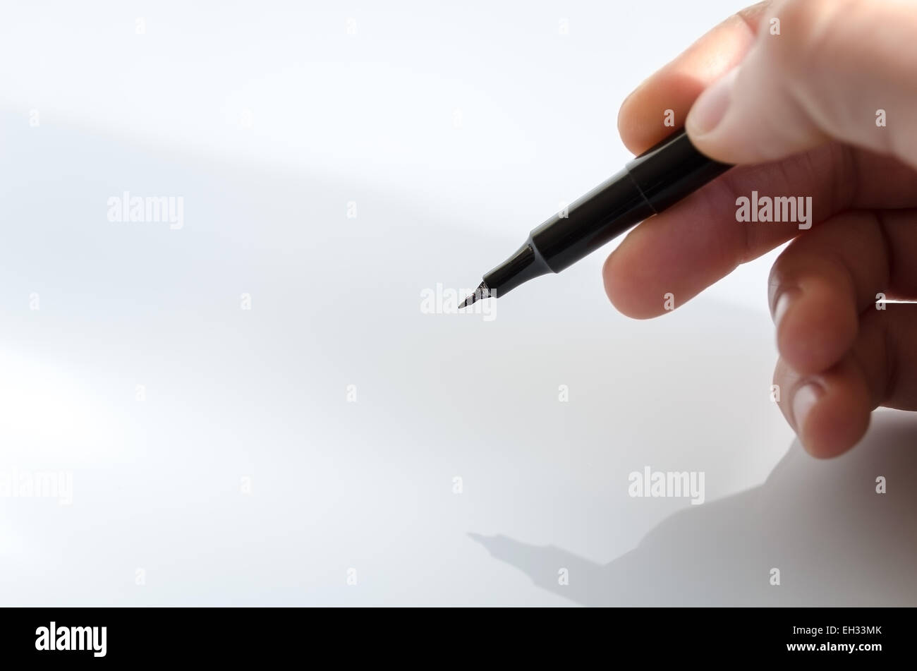 Pen in the hand isolated over white background Stock Photo - Alamy