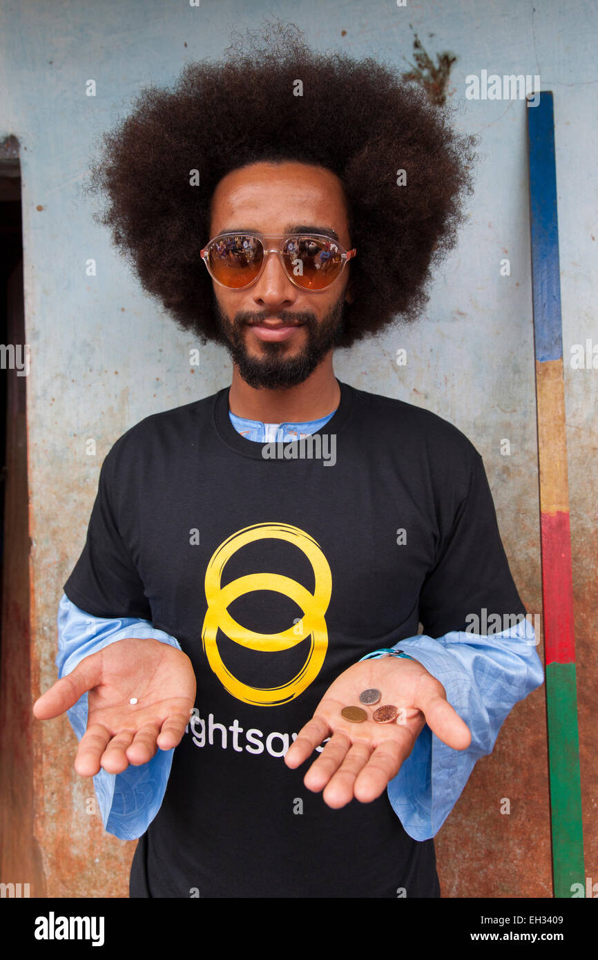 Benoit Assou-Ekotto, holding a tablet of Mectizan, the preventative treatment for  river blindness which cost £0.07. Stock Photo