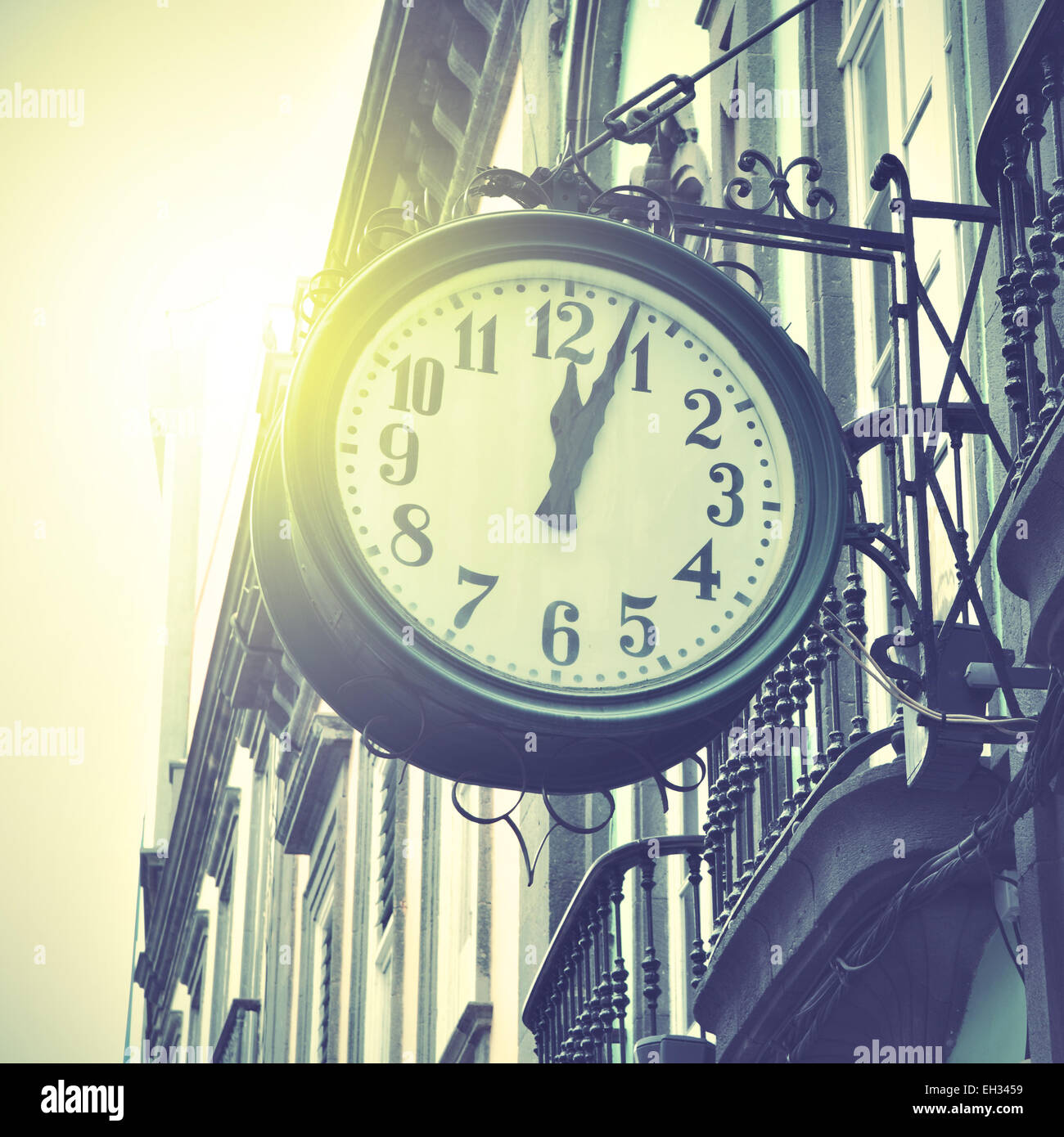 Old clock at railway station. Retro style filtred image Stock Photo