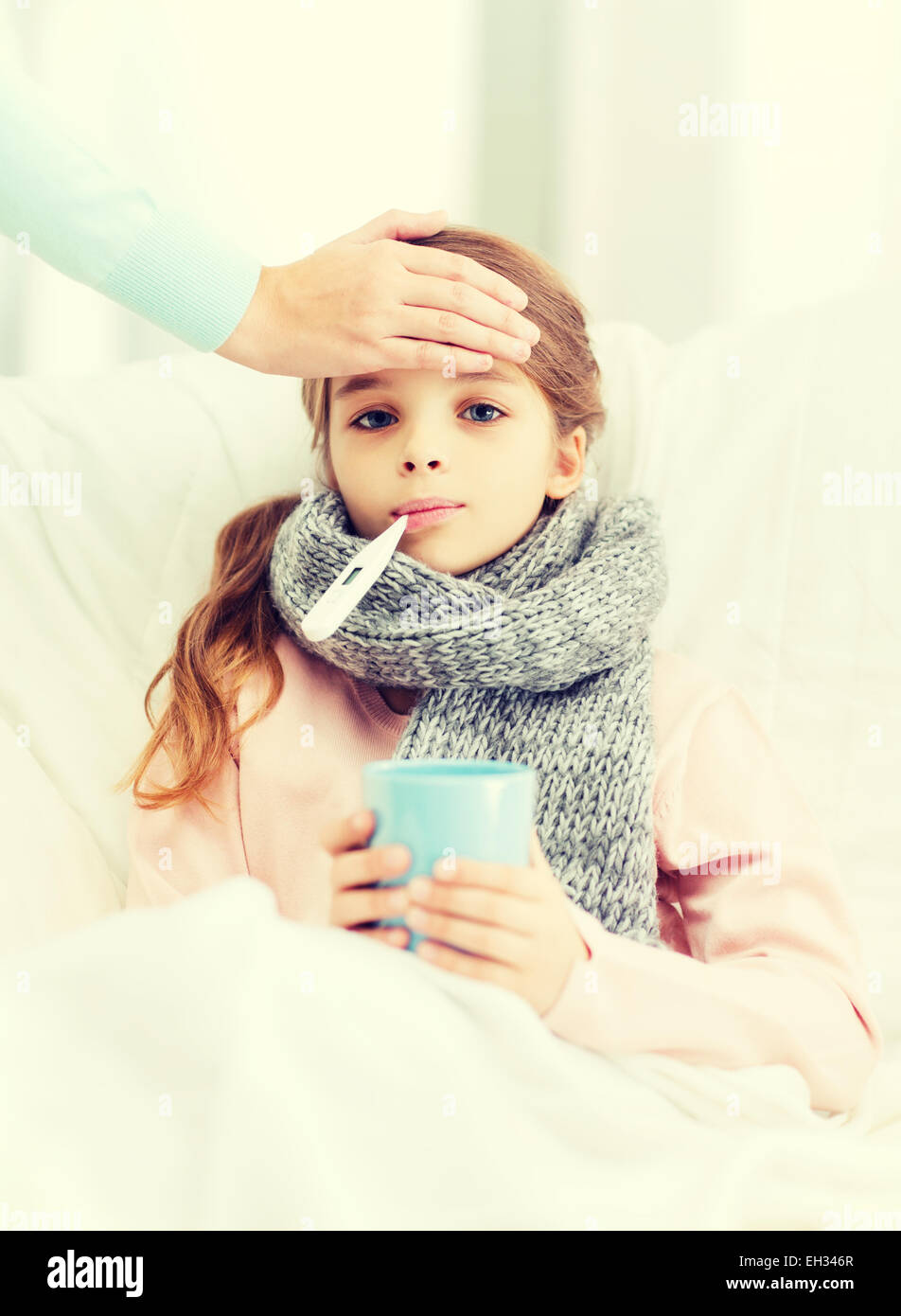 ill girl child with thermometer and caring mother Stock Photo Alamy