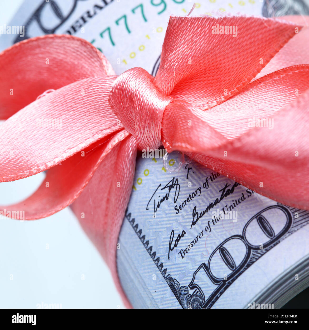 Roll of dollars with ribbon and bow Stock Photo
