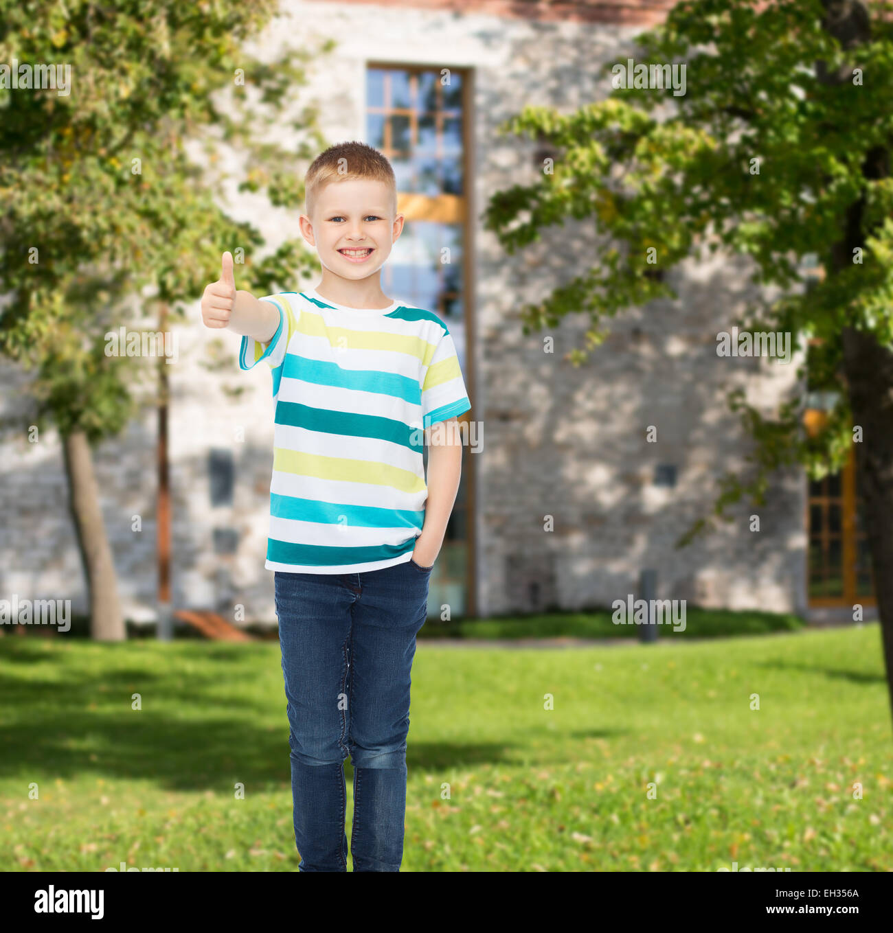 smiling little boy showing thumbs up Stock Photo - Alamy