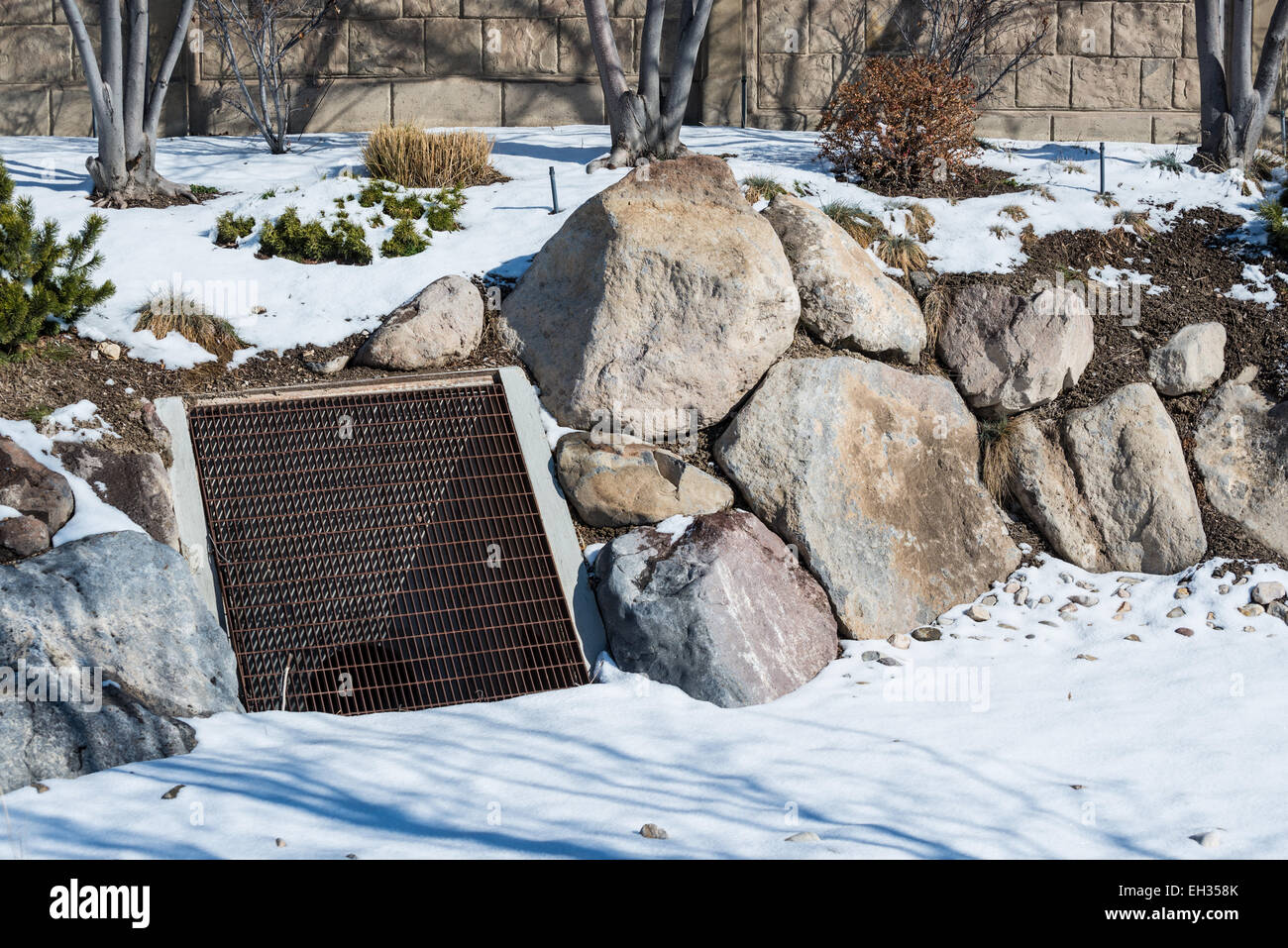 A storm drain within a bioswale and rain garden during winter Stock Photo