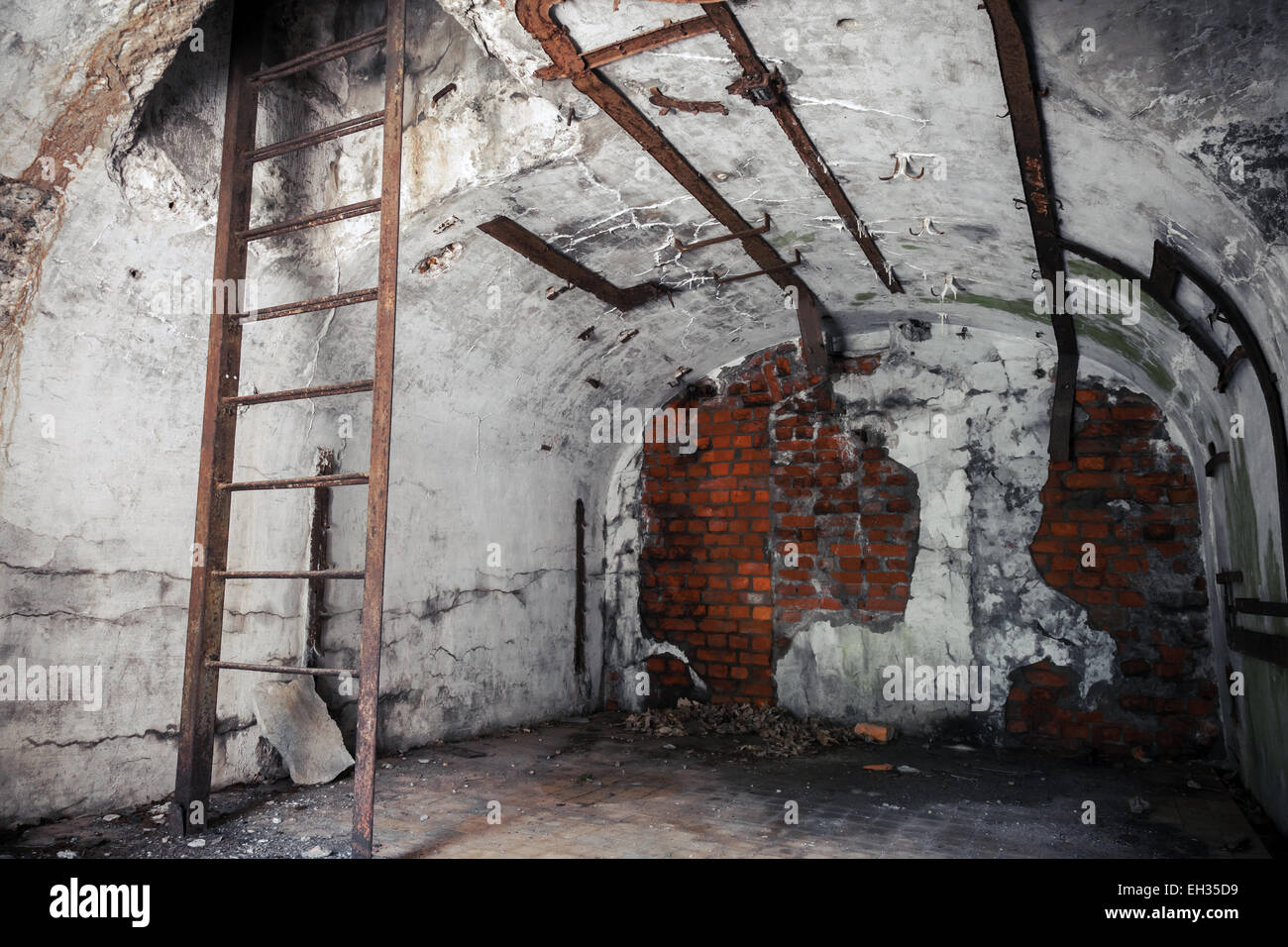 Old empty abandoned bunker interior with white walls and rusted constructions Stock Photo