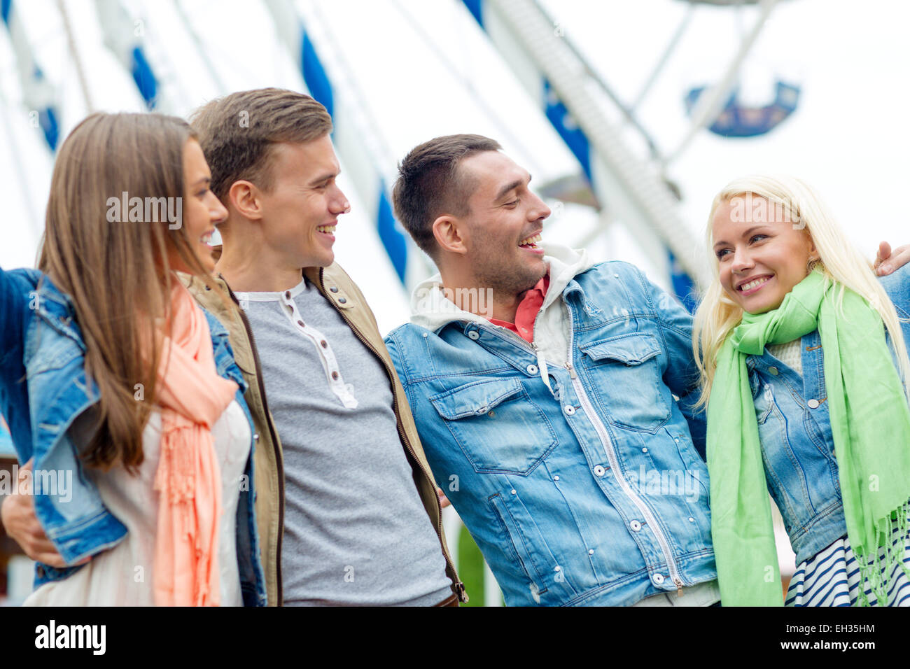 group of smiling friends in amusement park Stock Photo - Alamy