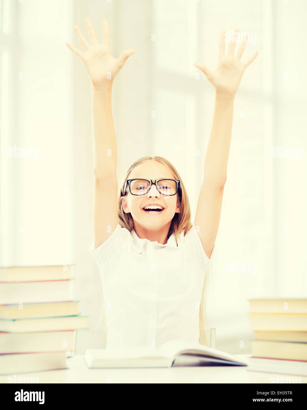 girl with books and hands up Stock Photo - Alamy