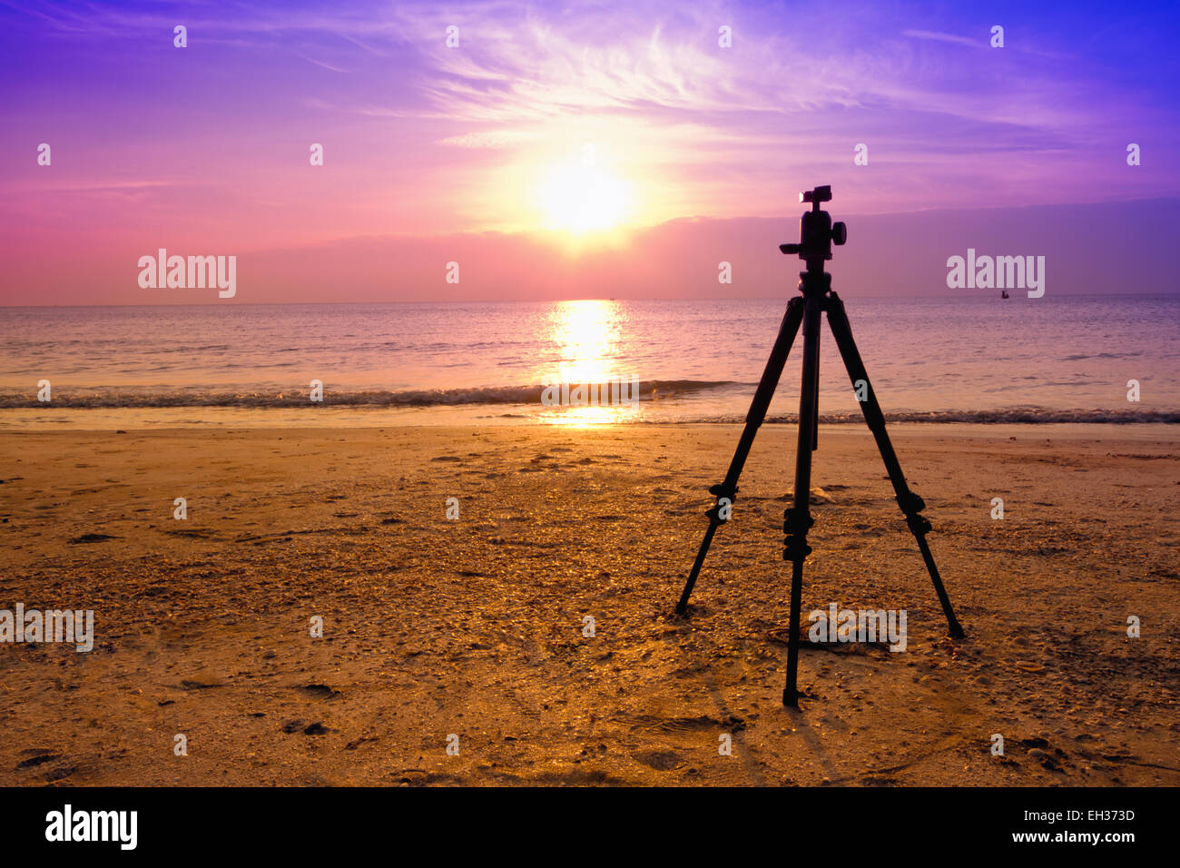 tripod over sun rising near the beach Stock Photo - Alamy