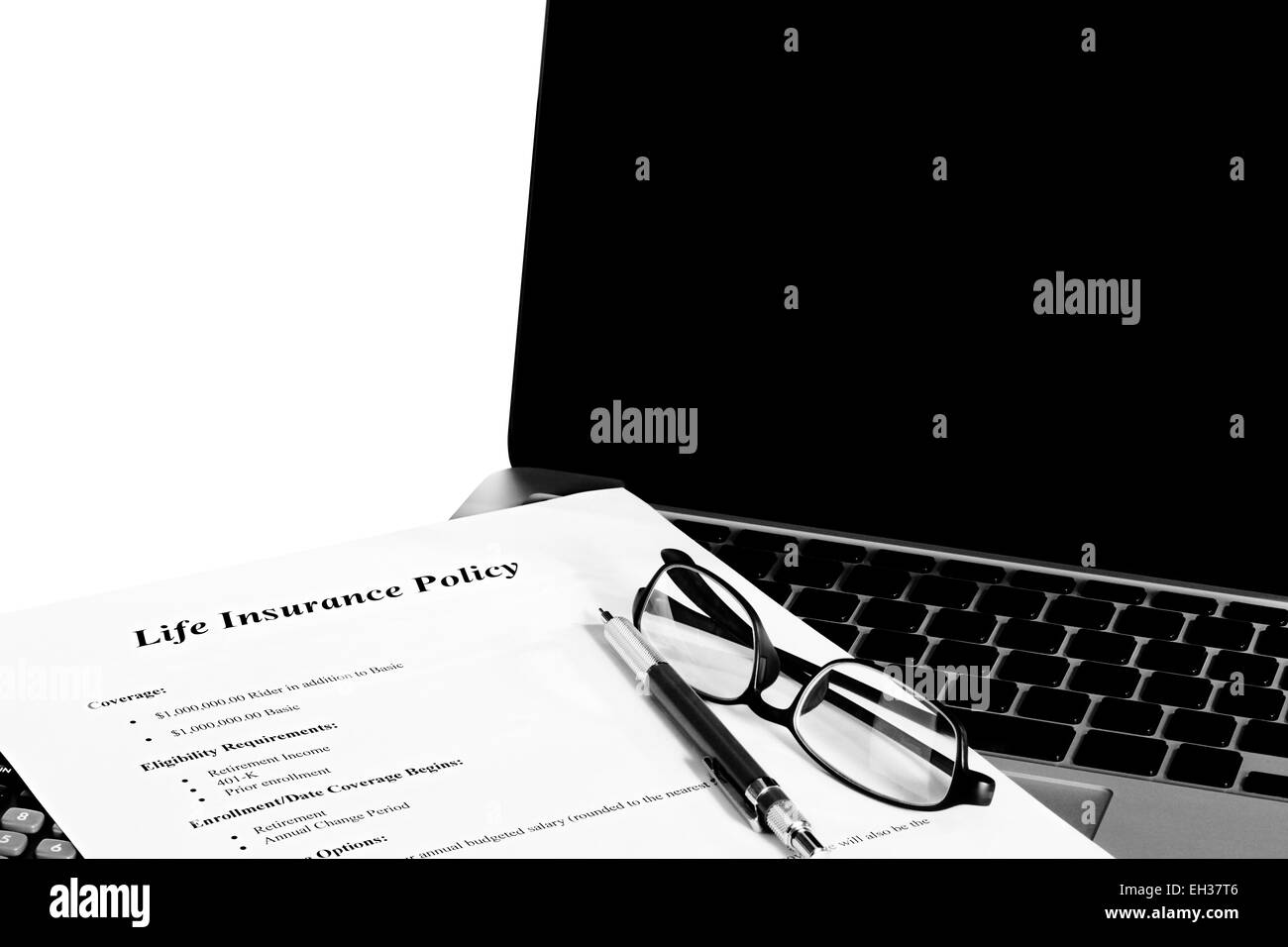 Sample Insurance Policy business document with laptop and calculator and reading glasses with white background and reminder Stock Photo