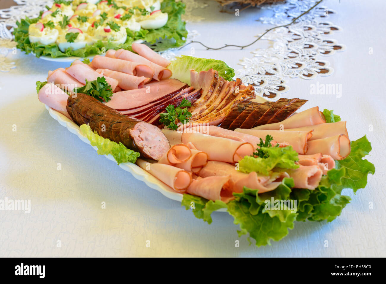 Assorted sliced ham, sausage and turkey arranged on a plate Stock Photo