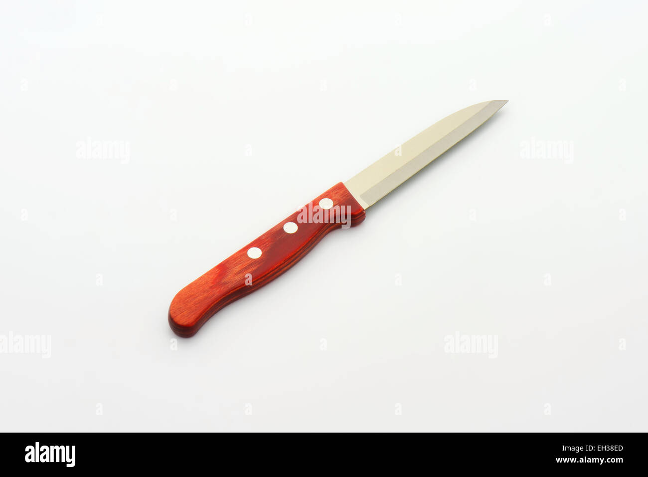 Small vegetable knife with wooden grip on white background Stock Photo