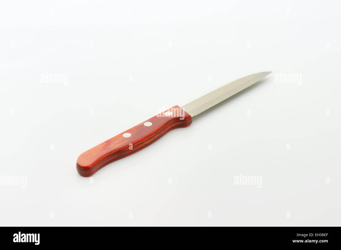 Small vegetable knife with wooden grip on white background Stock Photo