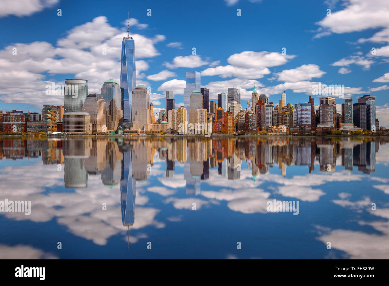 Lower Manhattan skyline panorama over East River with reflection and ...