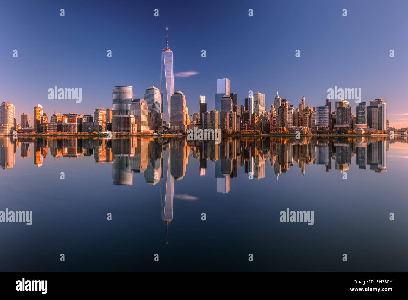 Lower Manhattan skyline panorama over East River with reflection at ...