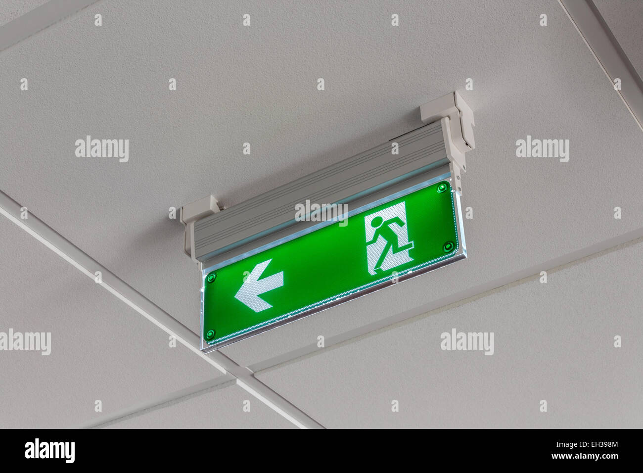 green exit sign pointing down Stock Photo