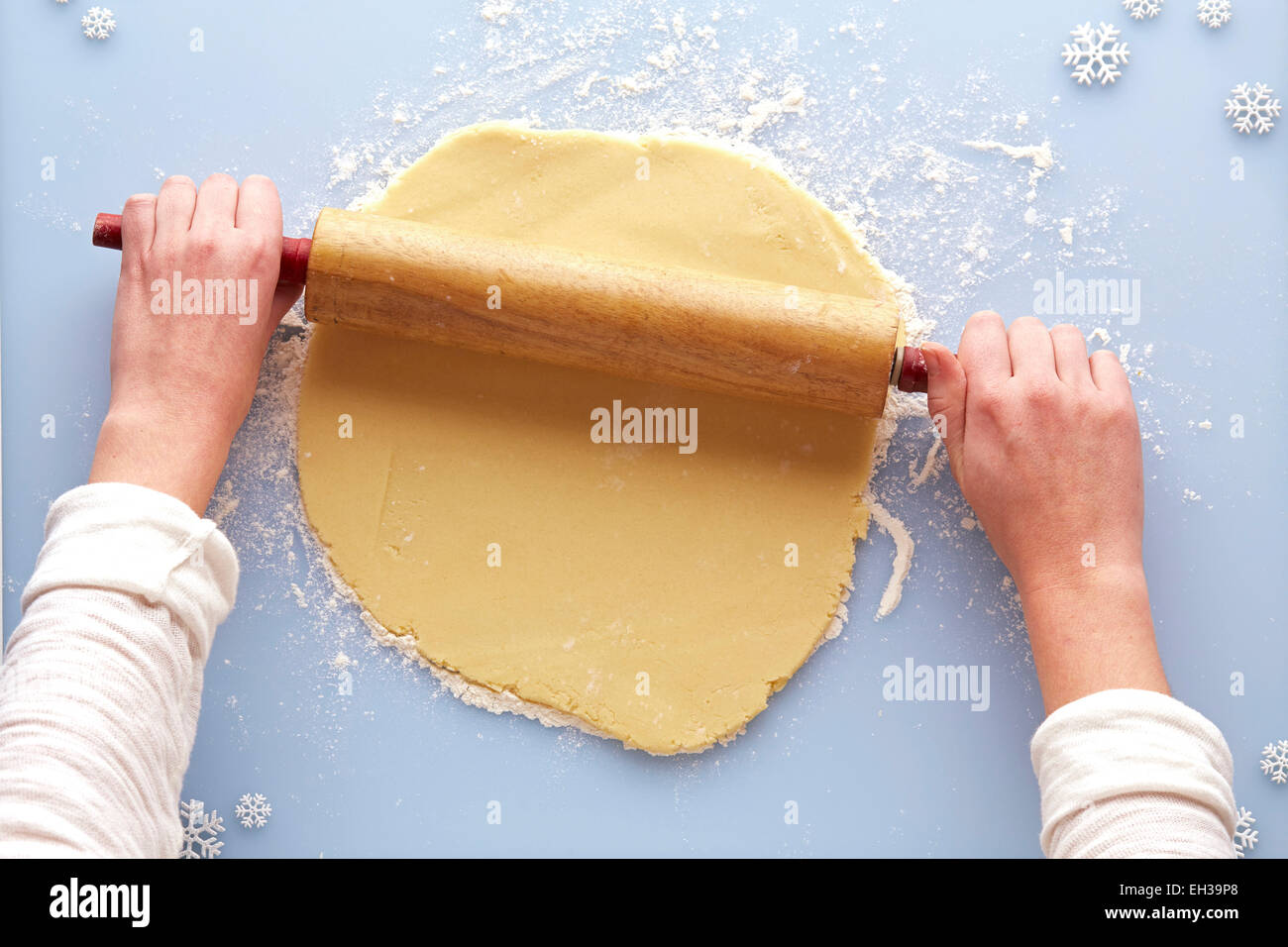 Overhead View of Woman Rolling out Sugar Cookie Dough, Studio Shot Stock Photo