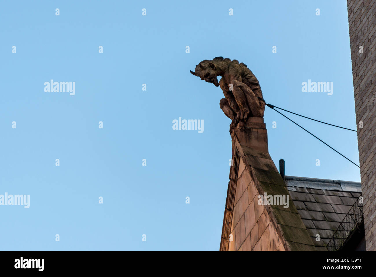 A grotesque like the devil looks out over the City of London on Cornhill, London Stock Photo