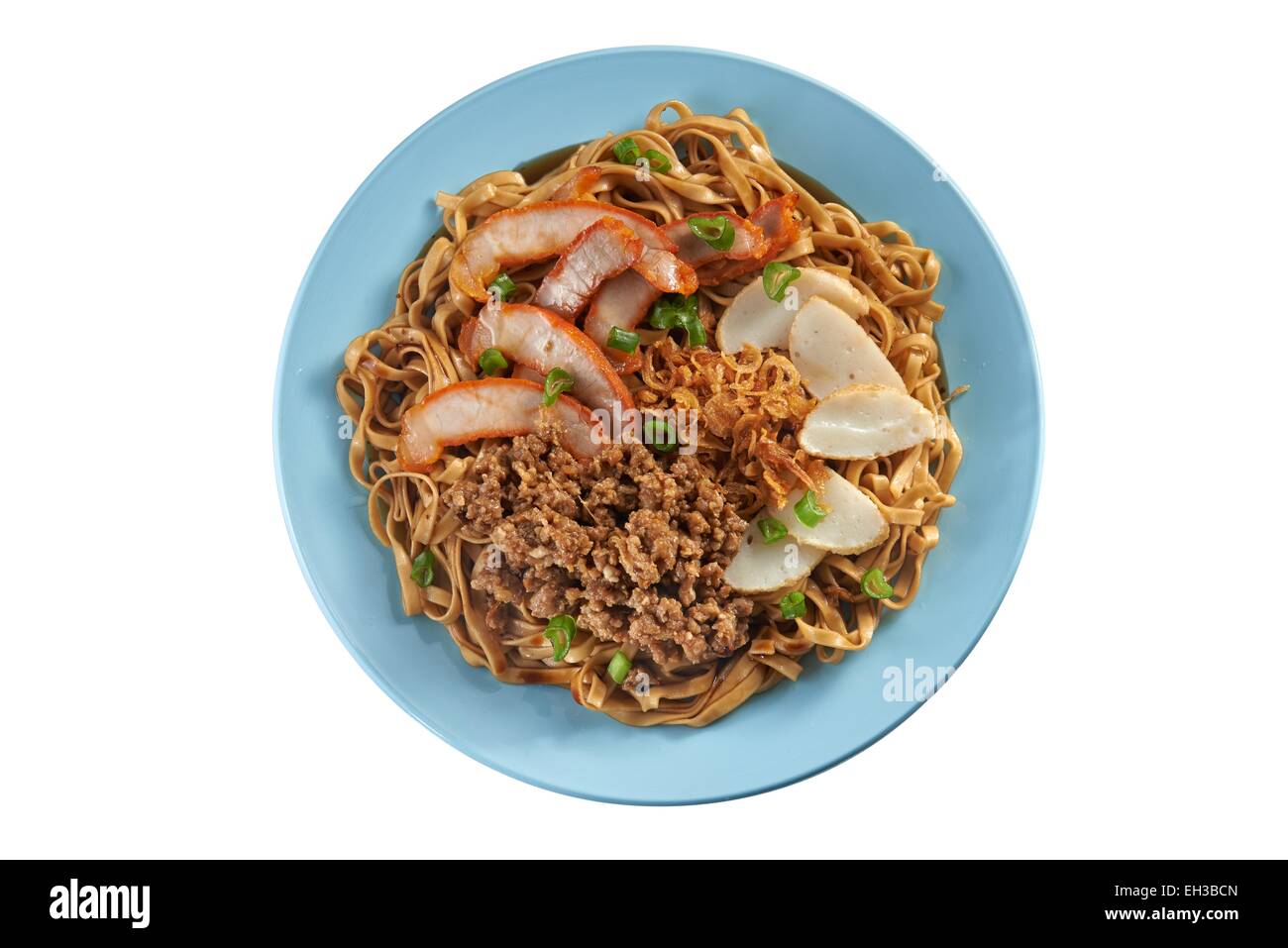 Fried noodle with pork sliced, fish cake and minced pork on clean background Stock Photo