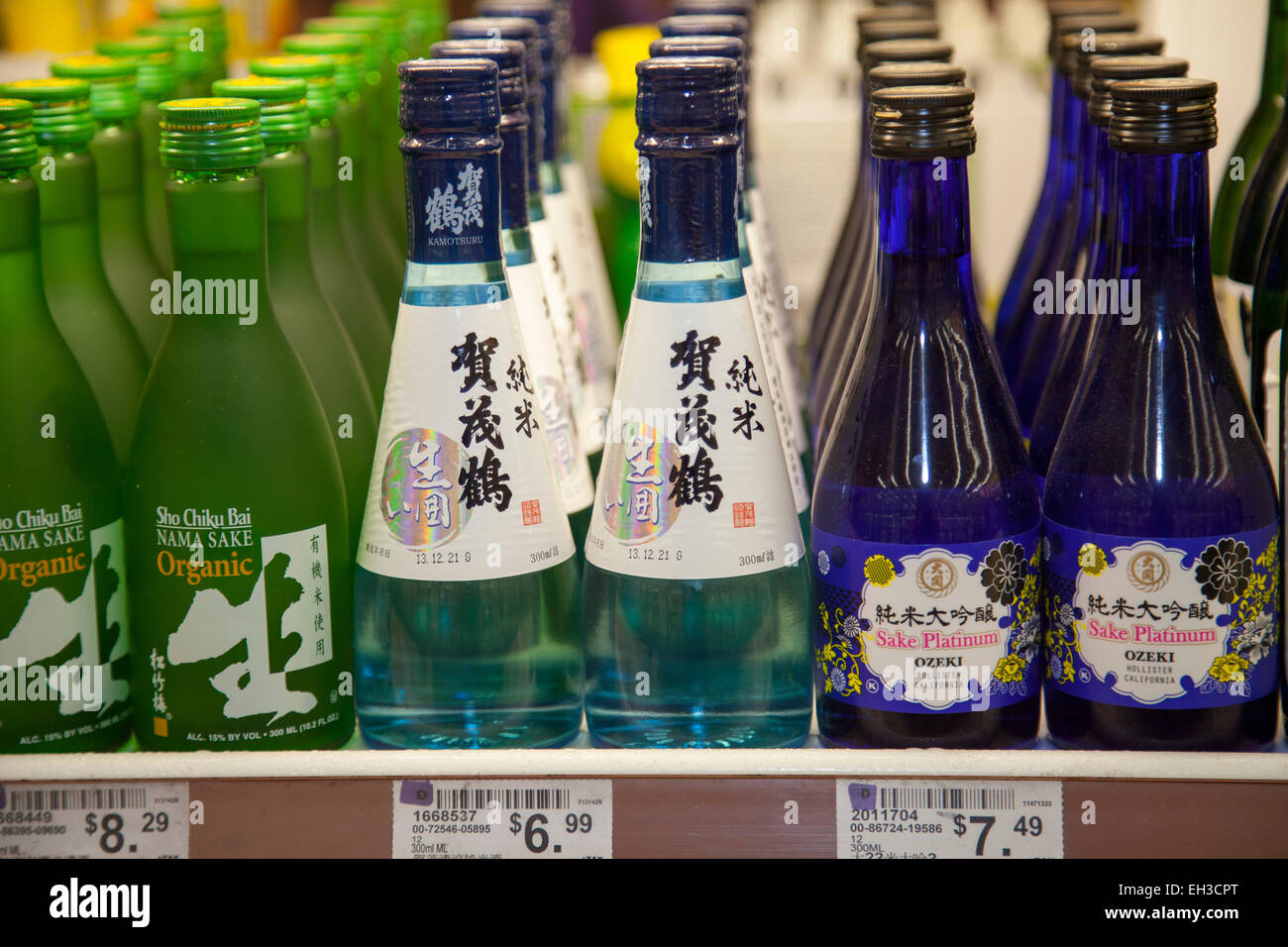 Sake wine bottles on the shelf in an Asian market, Richmond, California, USA. Stock Photo