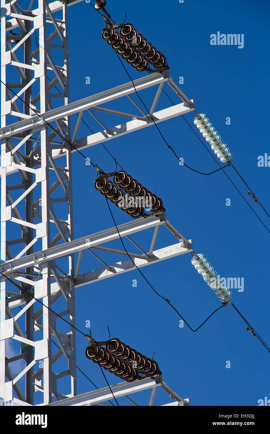 Electric power lines on a blue sky background Stock Photo - Alamy