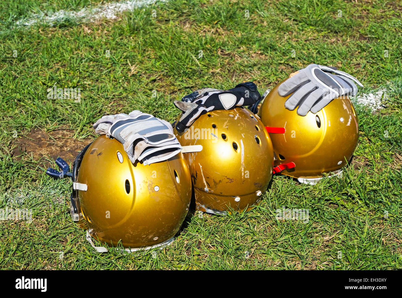 American football helmets in the grass Stock Photo - Alamy