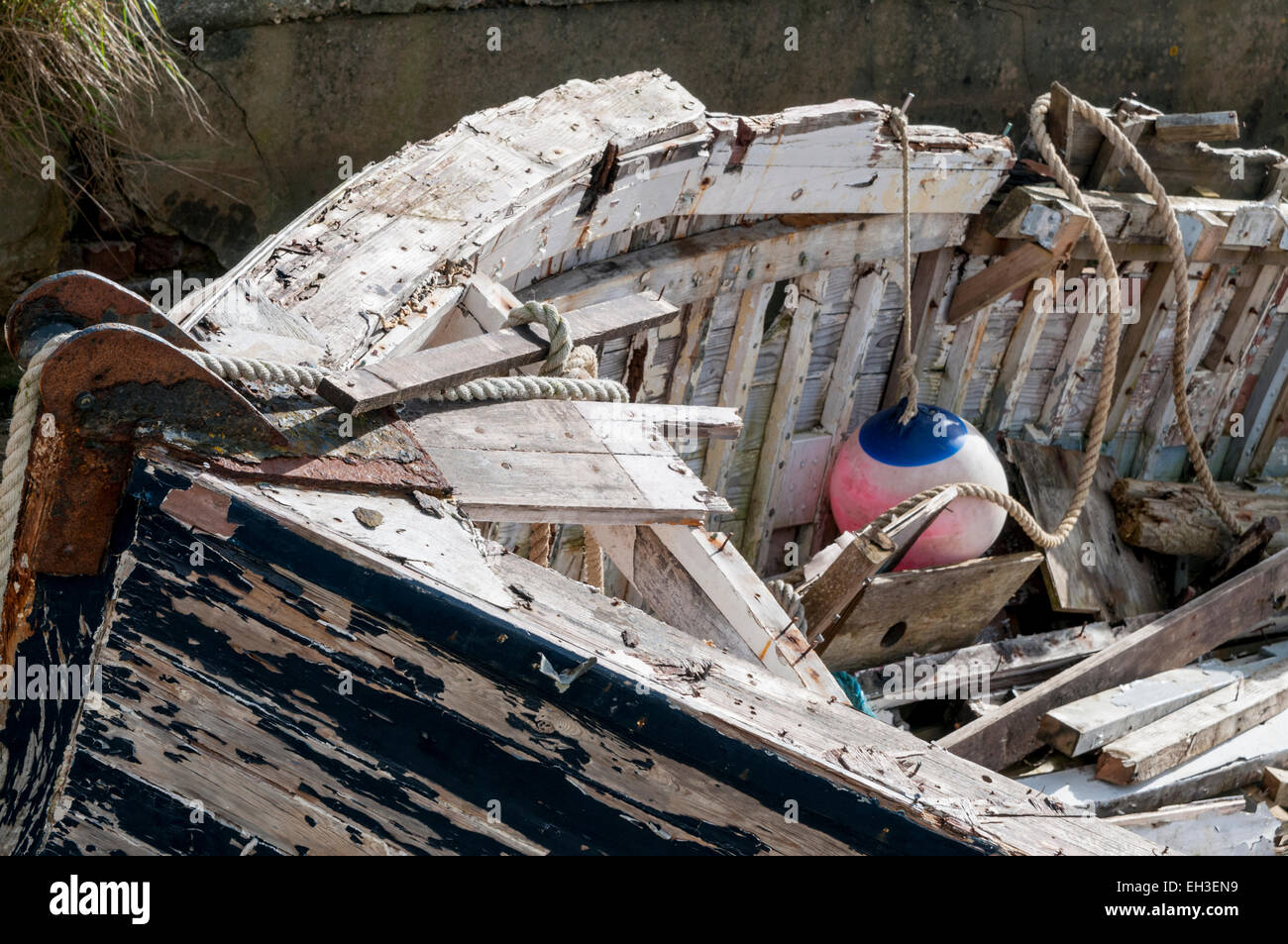 Close up of a small wooden boat that appears to have been abandoned on the river side at Littlehampton, West Sussex Stock Photo