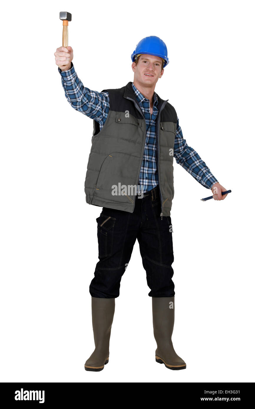 Laborer lifting hammer Stock Photo Alamy