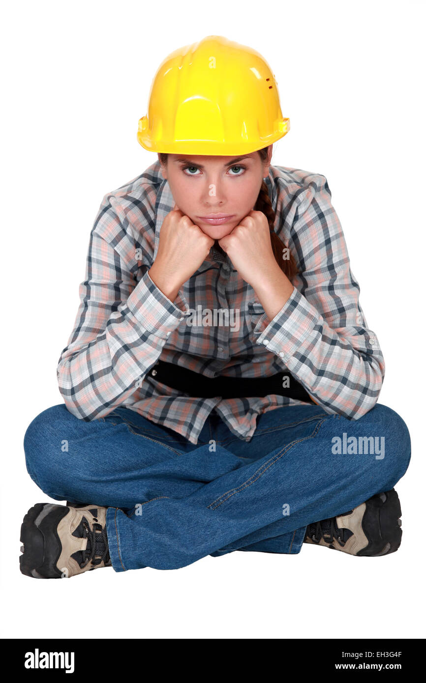 Gloomy female construction worker Stock Photo