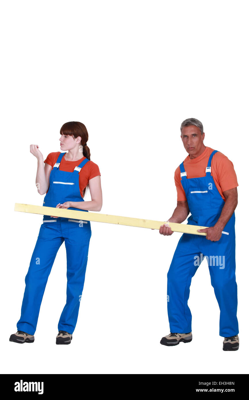 Man and woman holding wood Stock Photo