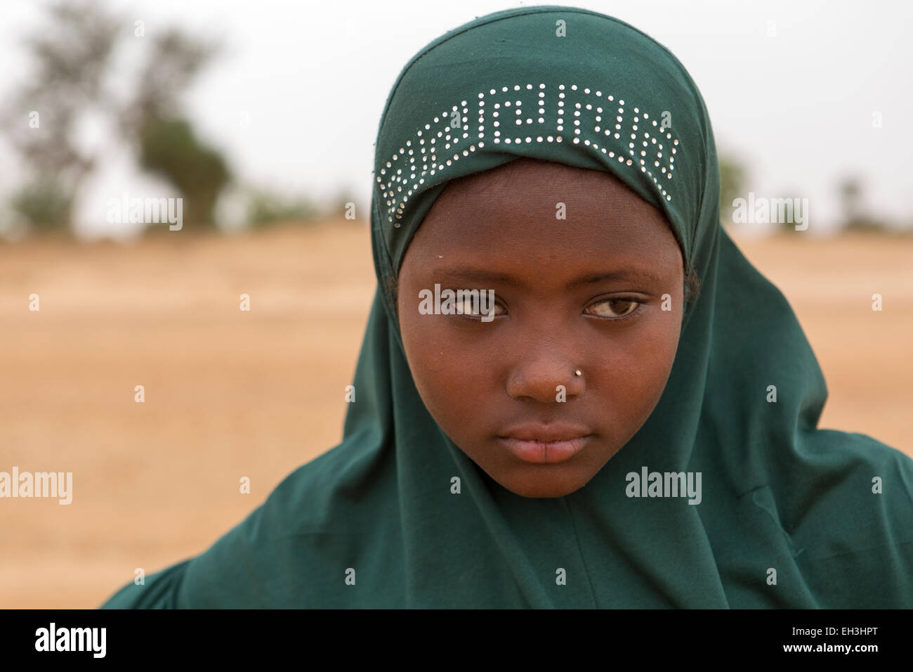 Western Niger, near Tera, 15th May 2012: Saffia Marou, 13, collects water from a hand dug well in a dry river bed. Stock Photo