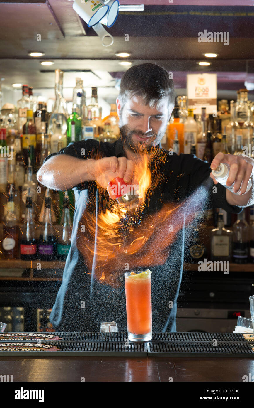A male barman, bar tender, mixologist makes a fantastic cocktail in a high end restaurant / bar / public house Stock Photo