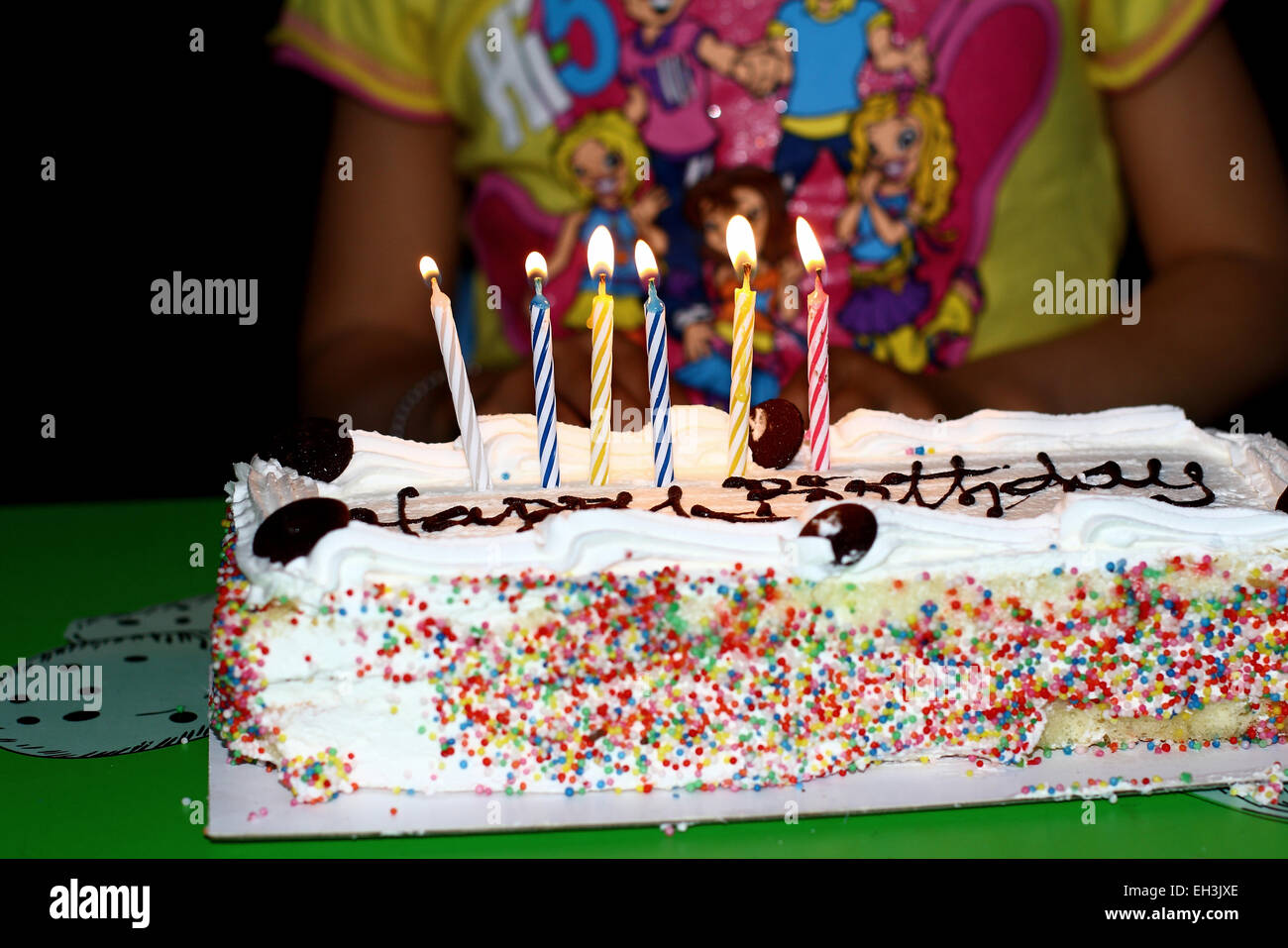 Colorful candles on birthday cake Stock Photo - Alamy