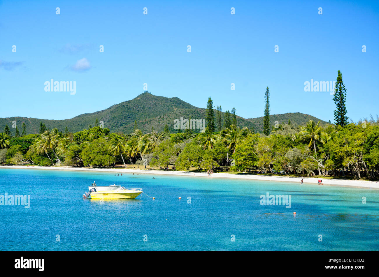 Tropical paradise with soft white sand, perfect blue sea and forest covered mountain. Stock Photo