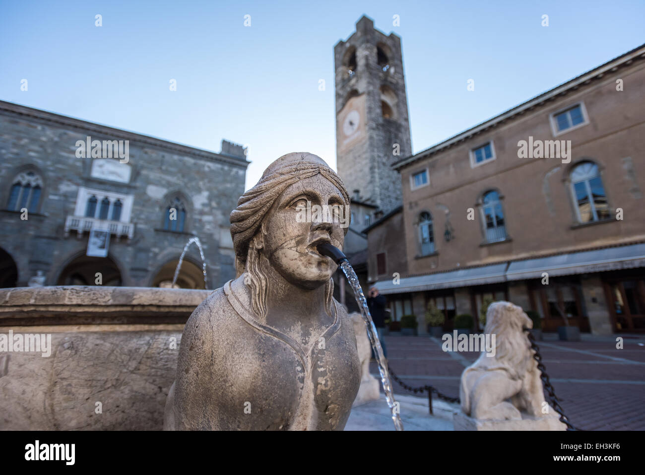 The Contarini fountain in the central square Piazza Vecchia in Bergamo, Italy. Palazzo del Podestà and bell tower in the back. Stock Photo