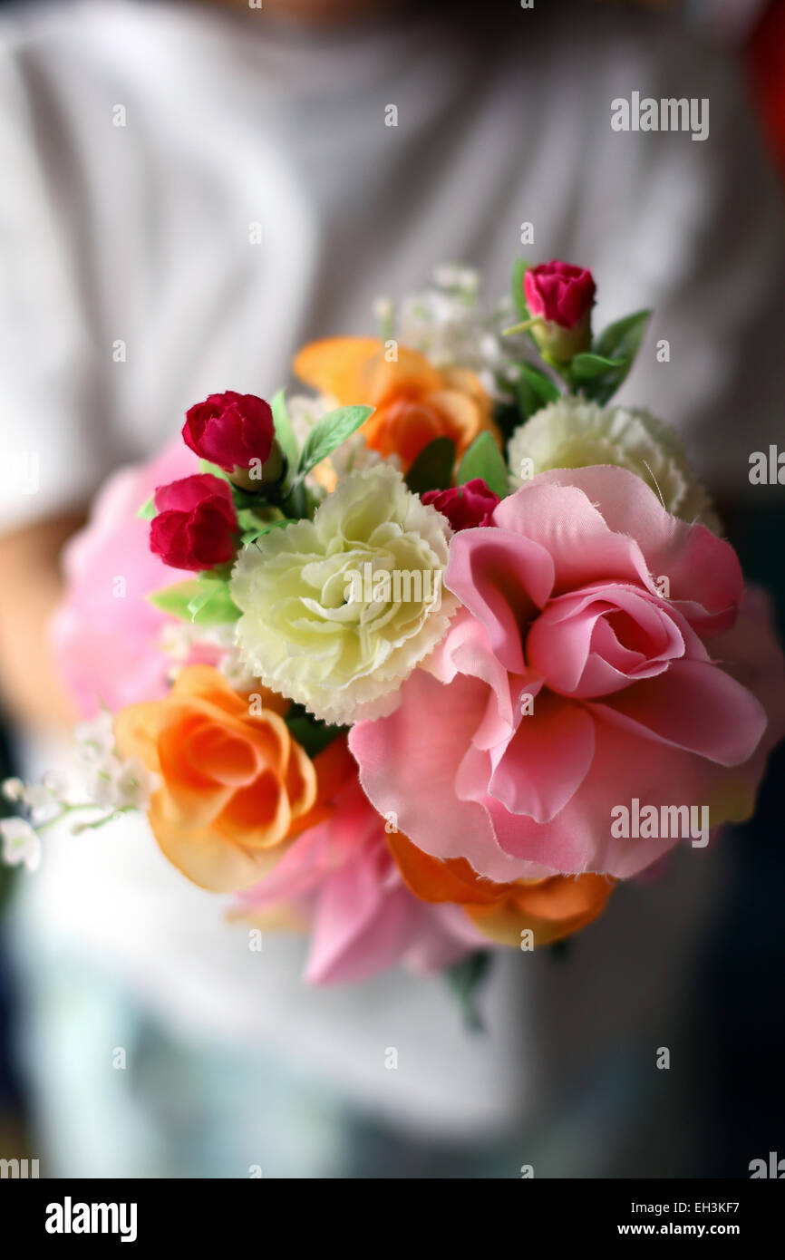 A child holding a bouquet of flowers Stock Photo
