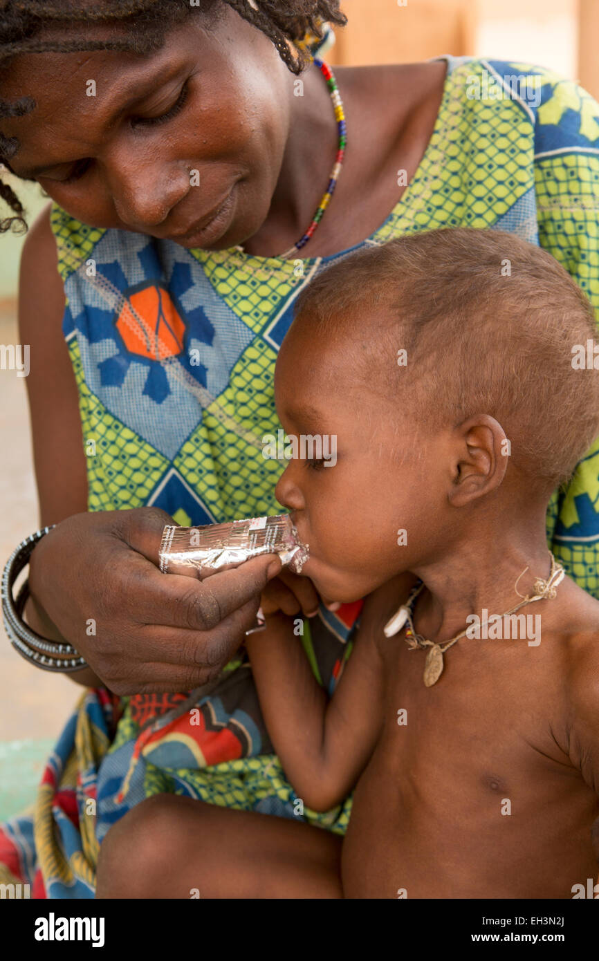 KOMOBANGAU, TILLABERI PROVINCE, NIGER, 15th May 2012: Fatimata Birma, and her son aged two, are treated at the health clinic for severe malnutition. Soumaila eats Plumpy Nut. Stock Photo