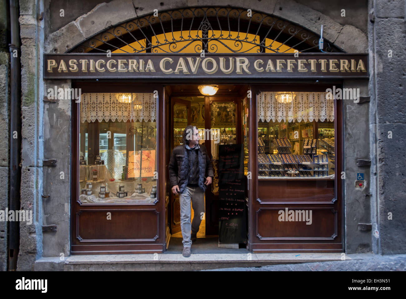Bergamo, Italy - A customer exits from Pasticceria, Caffetteria Cavour in Via Gombito, in the old town of Bergamo Alta Stock Photo