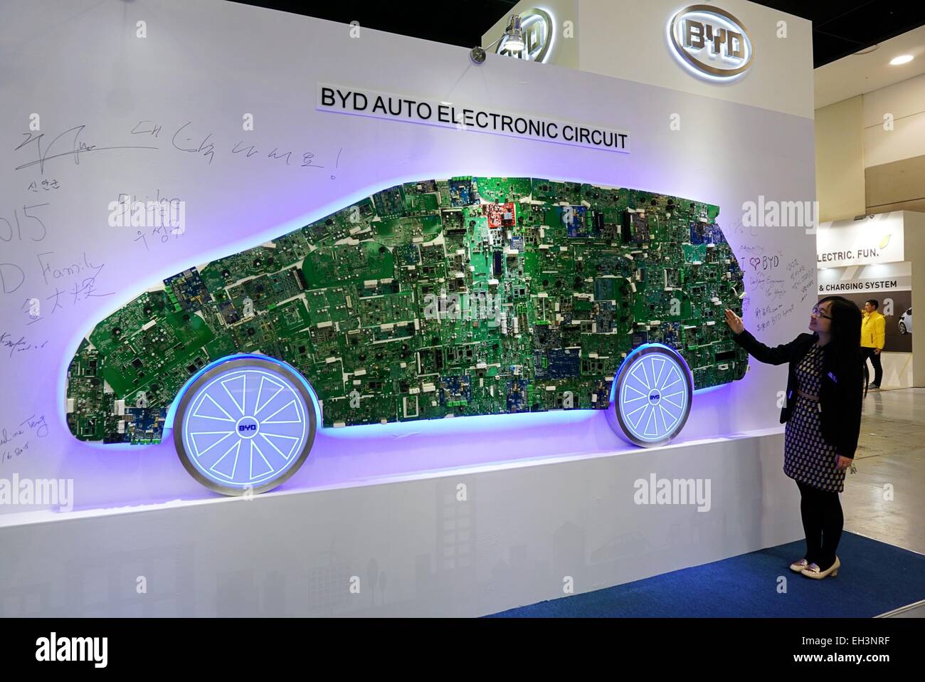 Jeju. 6th Mar, 2015. A staff of BYD Auto Co. introduces the electronic