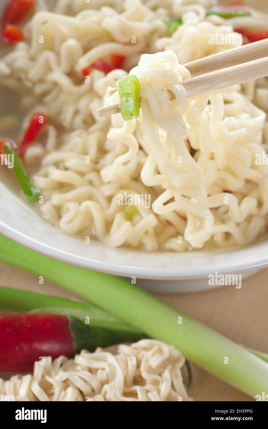 Noodle soup with spring onion and red chili pepper. Stock Photo