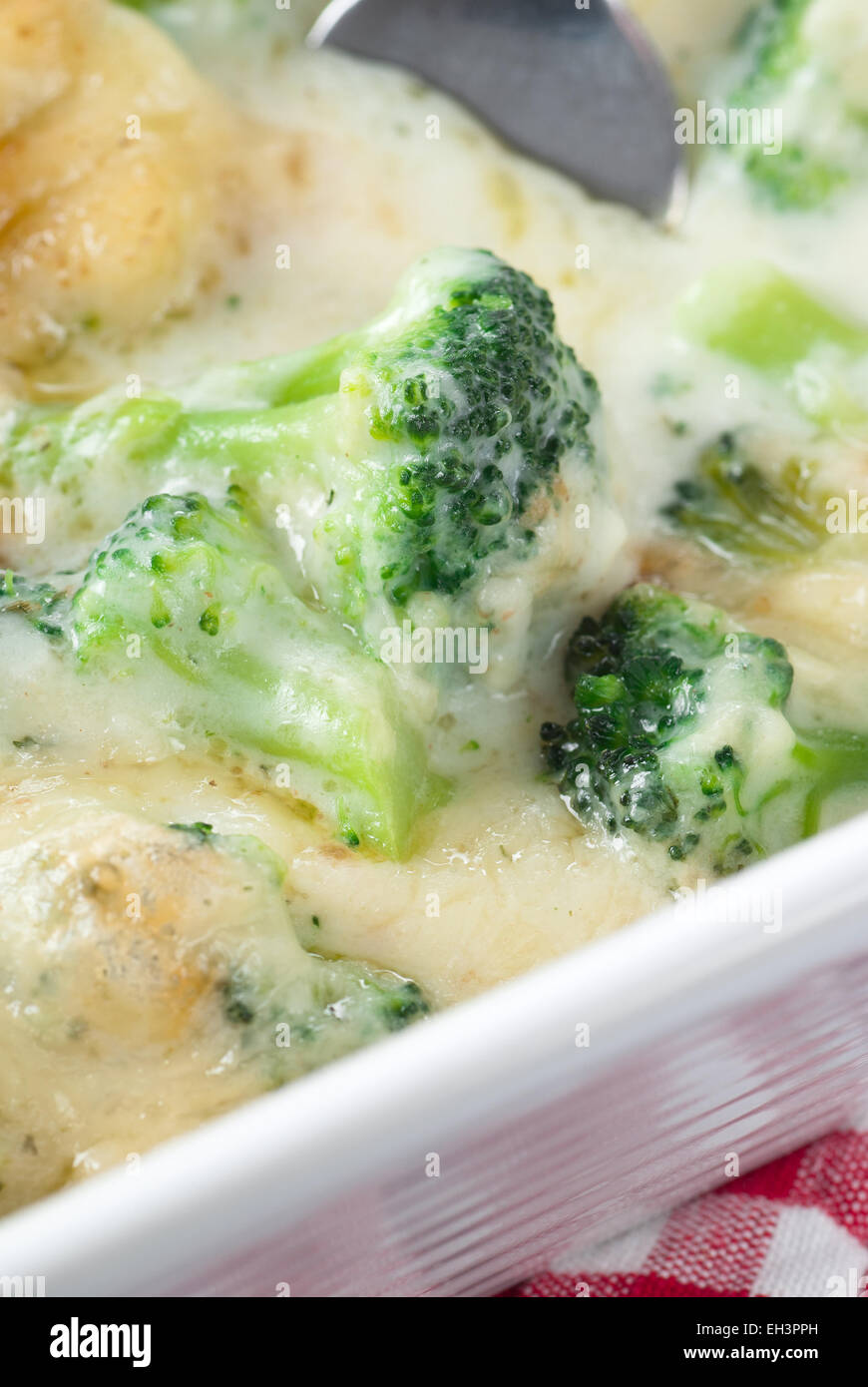 Broccoli gratin with melted cheese. Stock Photo